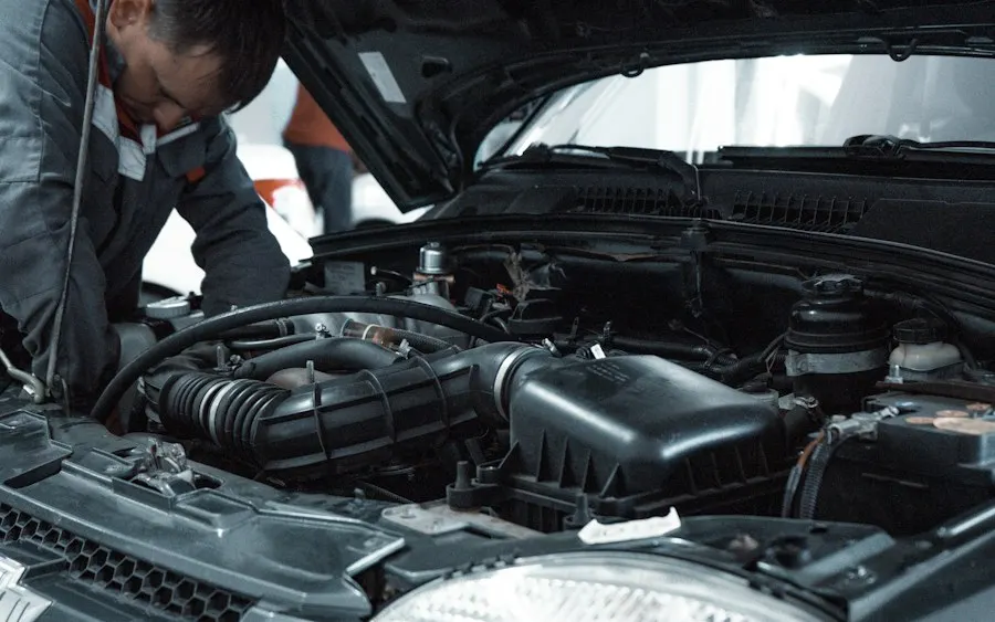 Technician inspecting an engine bay